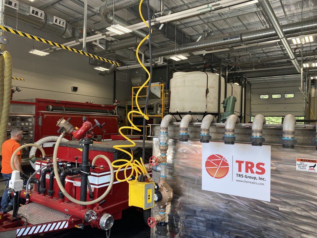 Greg Knight (izquierda) de TRS monitorea PerfluorAd mientras trabaja para eliminar PFAS del enjuague de vehículos de extinción de incendios en una estación de bomberos en Nueva Inglaterra.