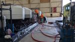 Two TRS system specialists work on the PerfluorAd system at Los Angeles International Airport.